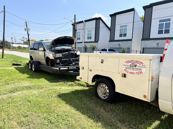 A tow truck towing a car on the back of it