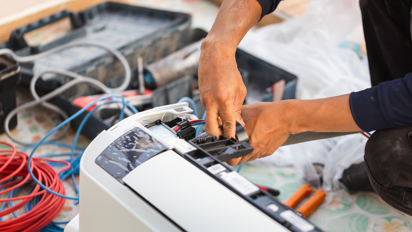 A man is working on an electrical device